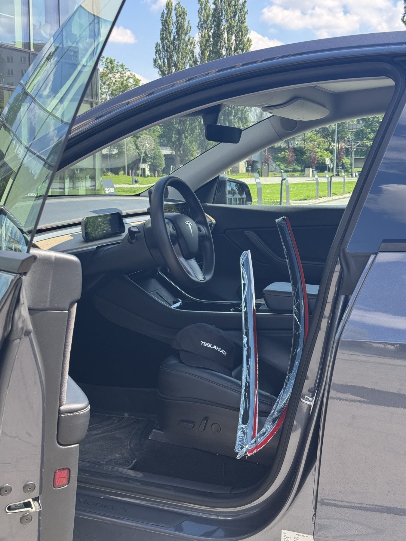 Fit test of a TeslaHubs part on an open Tesla door