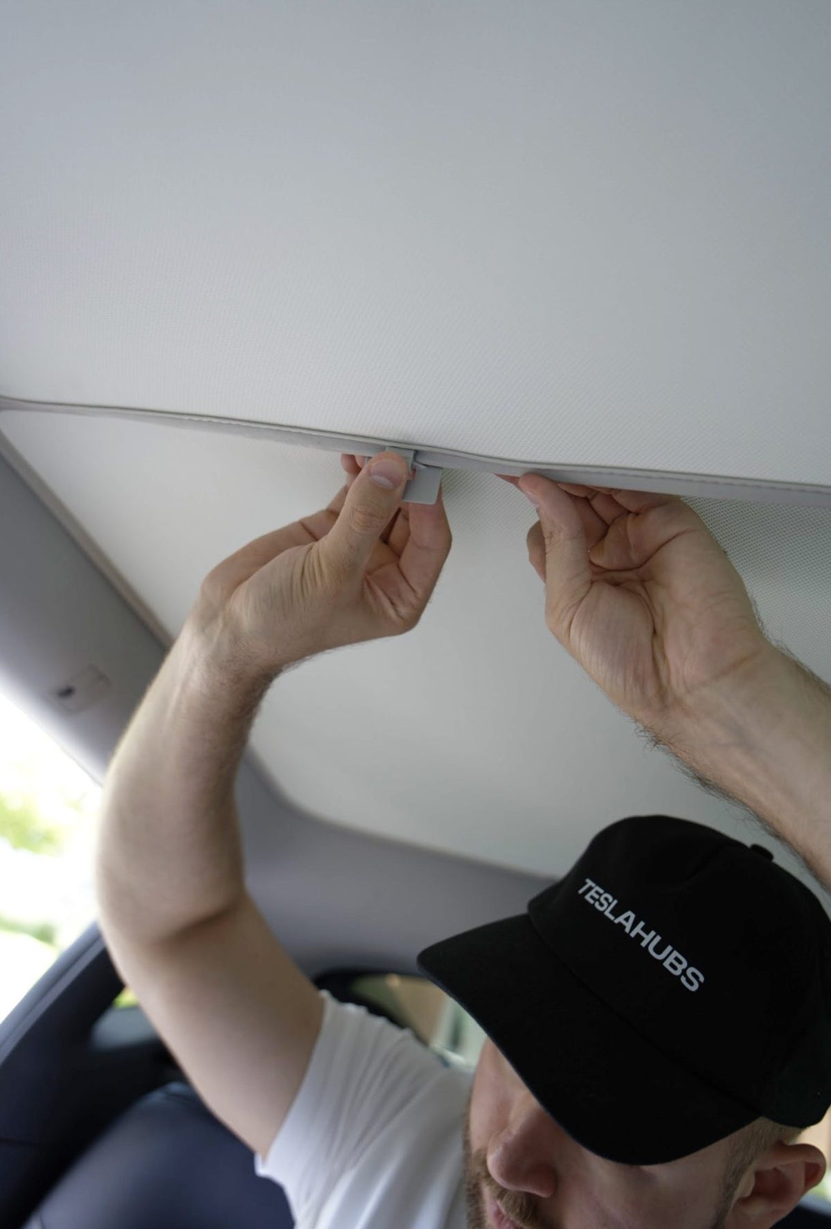 Teslahubs team member installing a sunshield in a Tesla