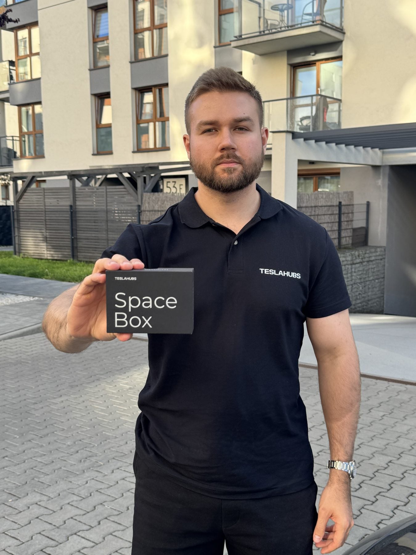 TeslaHubs team member holding a Space Box