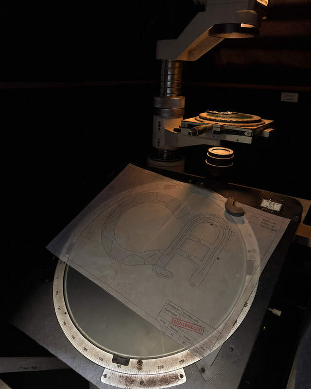 A part being measured against a template